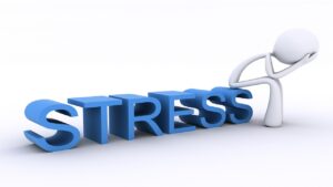 3D Character with head in hands, sitting on the word Stress